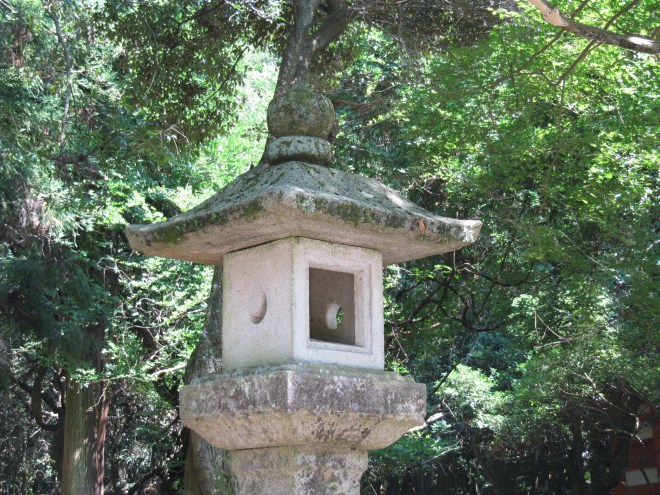 Both the sun and the moon are important in the rituals of Japan. They are both seen on this stone lantern at Nara, at least that's what I understand the crescent and circle illustrate.
