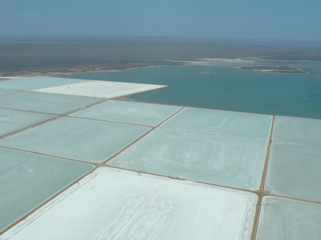 Aerial view of sea water drying in salt pans to become the salt of the earth, near Karratha, Western Australia.