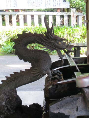 Dragon shaped water fonts are often found at Shinto Shrines signifying a strong connection with water. This dragon is delivering water to the chozubachi at at Hakone Shrine.