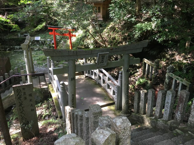 As well as the water sprinkled on the fire, the shrine in a secluded valley west of Kinpusen-ji Temple has a special water source said to promote good health. The temple and shrine are linked by hundreds of steps. Many torii are found along the downhill path. These three are next to a mountain stream that is flanked by two dragon-like images.