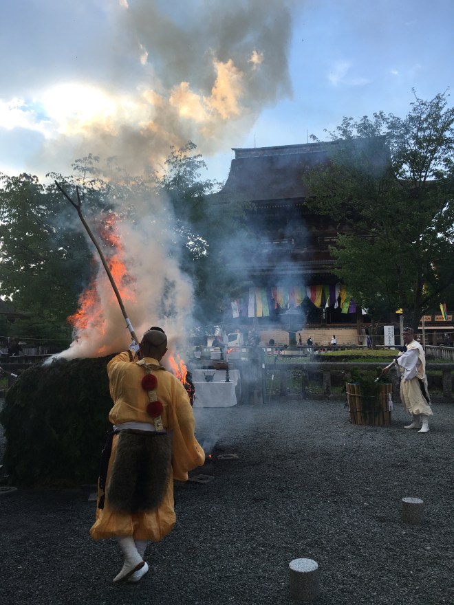 Here the saito-shi is tracing a letter symbolic of the Mahavairocana Buddha over the fire. Water is sprinkled periodically to prevent the fire from burning too quickly and to increase the purifying smoke. Further details of the ceremony can be found in an informative article by Paul L. Swanson written in 1981.