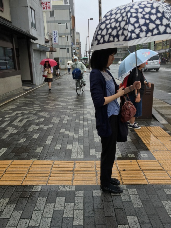 Japanese people still ride their bikes in the rainy season, either donning wet weather gear as in this image, or holding umbrellas when they are riding. Occasionally an umbrella was fixed to the bike itself. I wasn't able to get a photo of that.